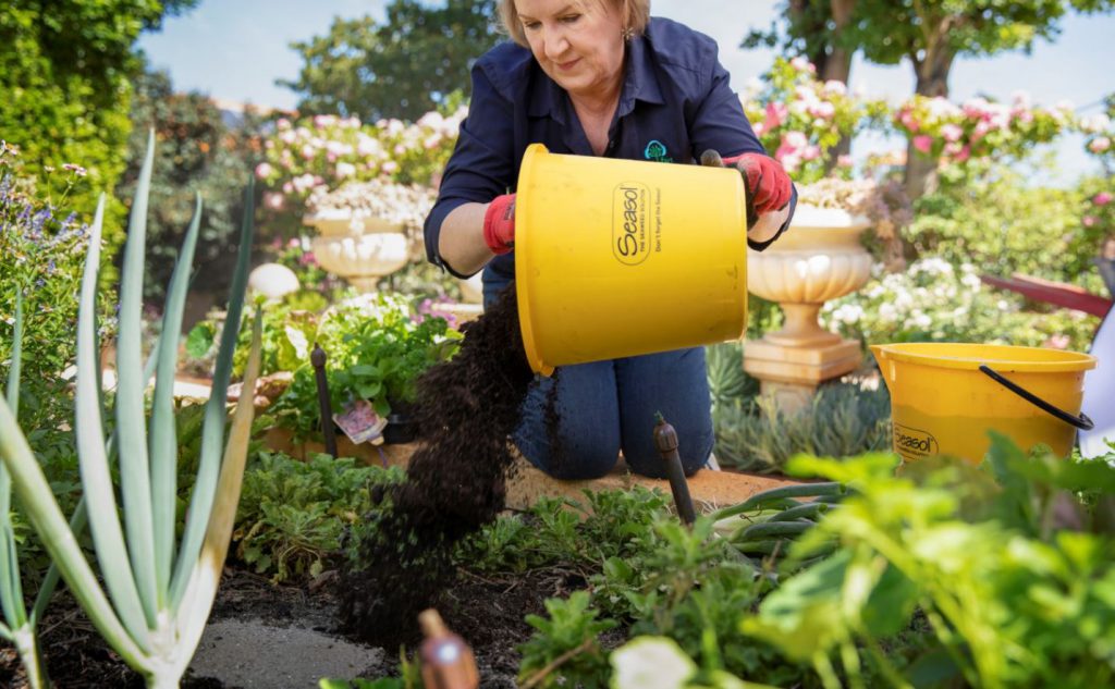 Deryn preparing the soil for more fresh produce to flourish in