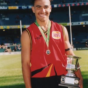 Jeff receiving the championship trophy as the captain for the 1st XVIII- winning the Quit Cup in 2001