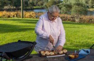 Dale Tilbrook Aboriginal woman making damper rolls with native quandong jam